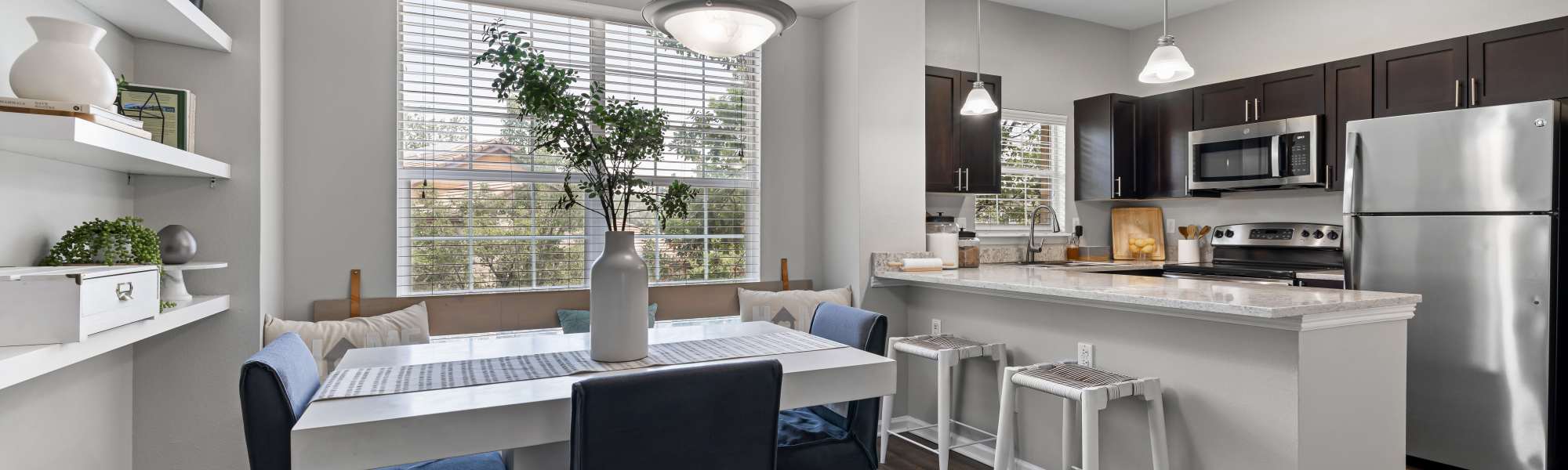 Model kitchen and dining room at Isabella Apartment Homes in Greenwood Village, Colorado
