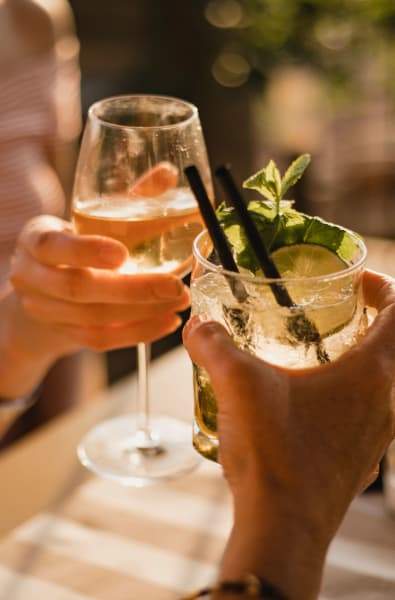 Friends drinking wine together in Pompano Beach, Florida near Linden Pointe