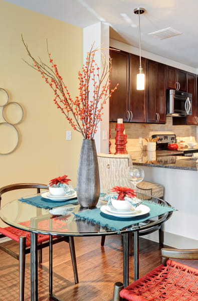 Dining area looking into the kitchen at The Mark at Brickyard Apartment Homes in Beltsville, Maryland.