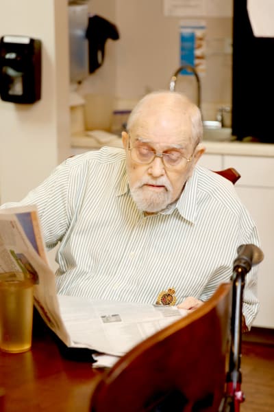 A resident reading the newspaper at Providence Assisted Living in Grenada, Mississippi. 
