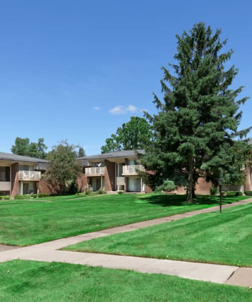 Expansive lawn and walking paths at Kensington Manor Apartments in Farmington, Michigan