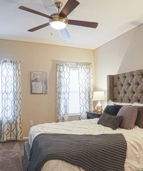 Bedroom with ceiling fan and natural light at La Maison Of Saraland, Saraland, Alabama