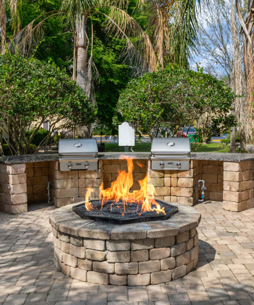 Fire pit and BBQ grills at Citrus Tower | Apartments in Clermont, Florida