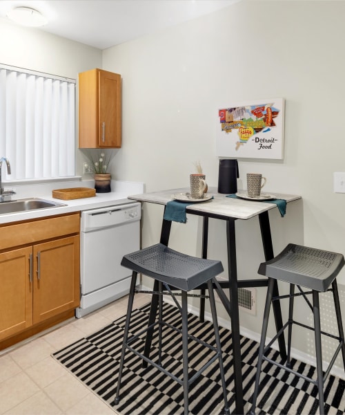 Eat-in kitchen with a dishwasher at Fairmont Park Apartments in Farmington Hills, Michigan
