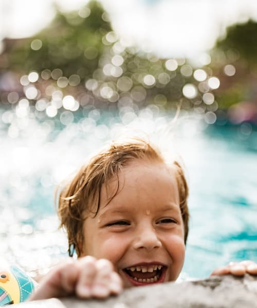 Young resident playing in the swimming pool at Briar Cove Terrace Apartments in Ann Arbor, Michigan