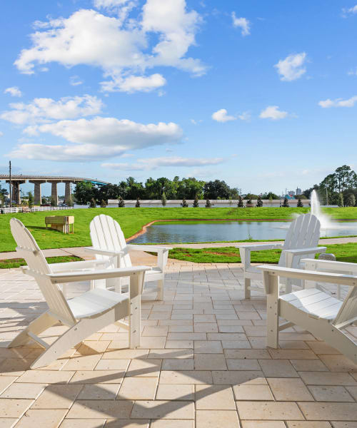 Lounge chairs near the pond at Altura | Apartments in Pensacola, Florida
