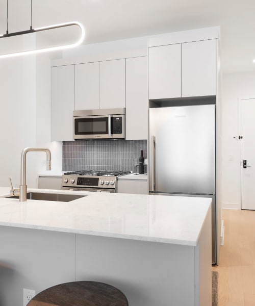 Rendering kitchen apartment at 8 Court Square in Long Island City, New York