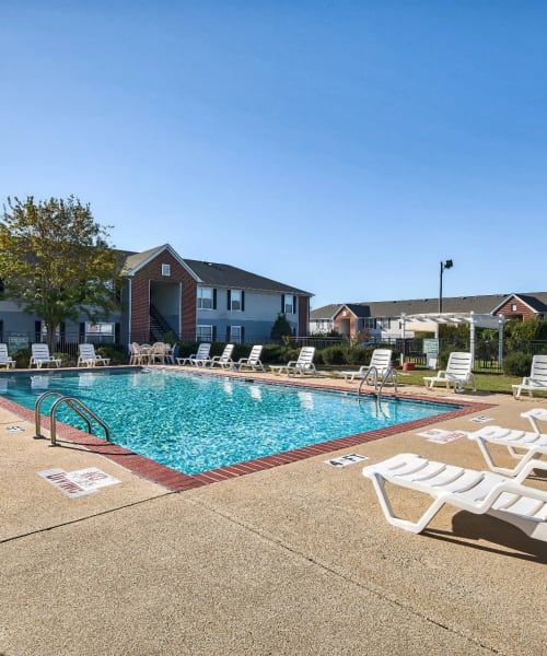 The community swimming pool surrounded by lounge chairs at Reserve at Stillwater in Durham, North Carolina
