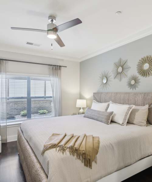 Bedroom with vaulted ceilings and a ceiling fan at Somerset in McDonough, Georgia