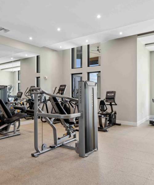 Fitness studio with ample equipment at Residences Of Highland in Hialeah, Florida