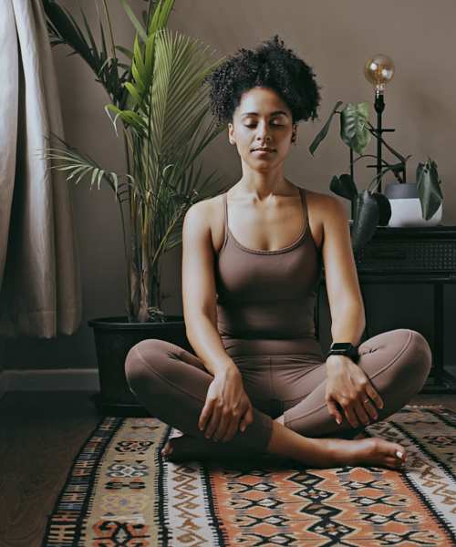 Resident practicing yoga in a spacious bedroom at Firwood Station in Portland, Oregon