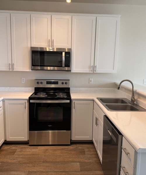 Kitchen with large wooden cabinet at Chinook Way Apartments in Fairview, Oregon