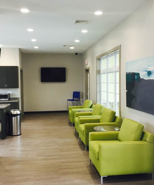 Community clubhouse with couch and wood-style flooring Heather Ridge Apartments in Columbia, Missouri