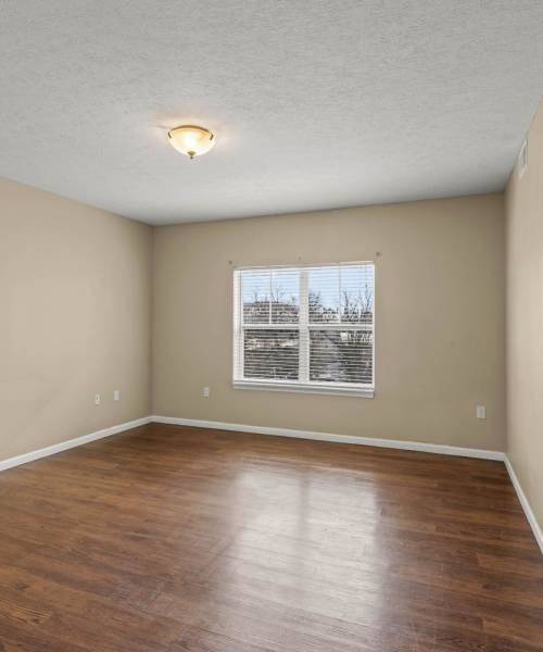 Well-lit and spacious living room with LVT flooring at Gateway Senior Housing in Waynesburg, Pennsylvania