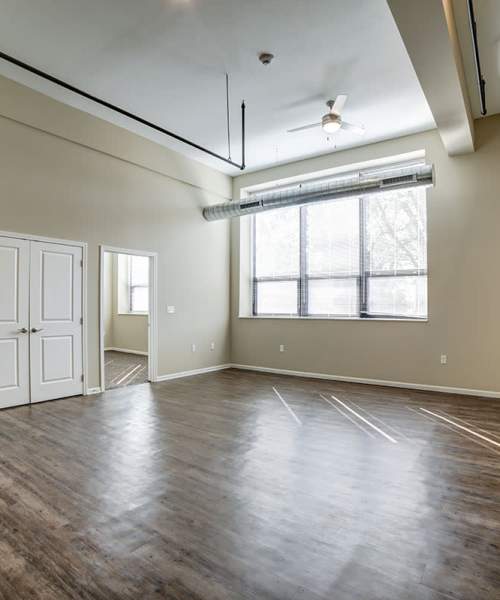 Spacious living room with LVT flooring at Willow Commons Apartments in Erie, Pennsylvania