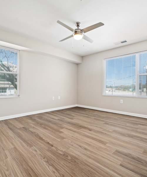 Spacious bedroom with wood-style flooring at Five Points Crossing in Rocky Mount, North Carolina