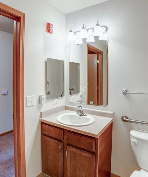 Bathroom with vanity mirror at Quaker Meadows in Hermitage, Pennsylvania