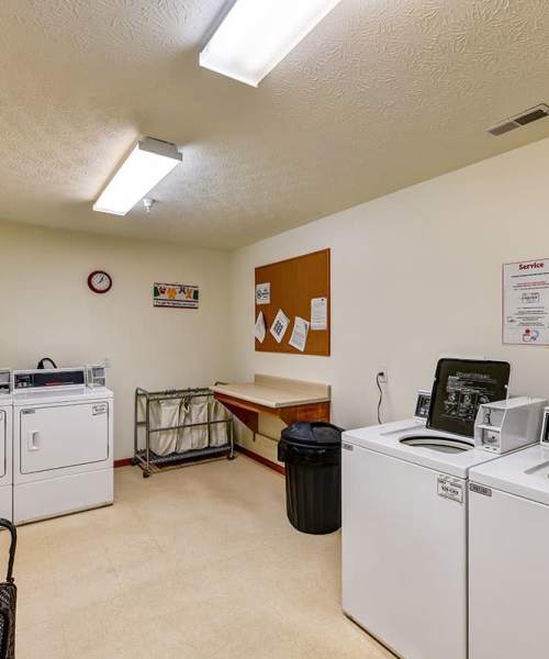 Laundry room with washers and dryers at Beaumont Greene Senior Living in Athens, Ohio