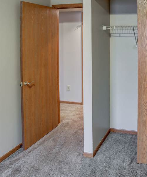Carpeted hallway with open closet at Riverview Place in Ripley, Ohio