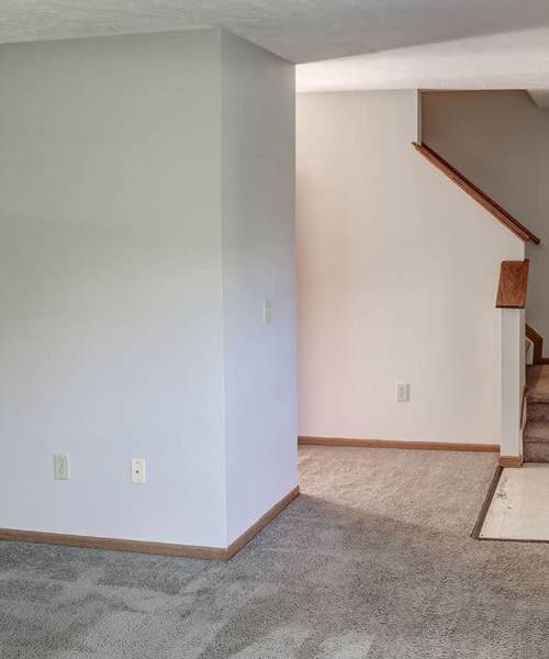 Living room with stairs at Ivy Glen in Washington Court House, Ohio