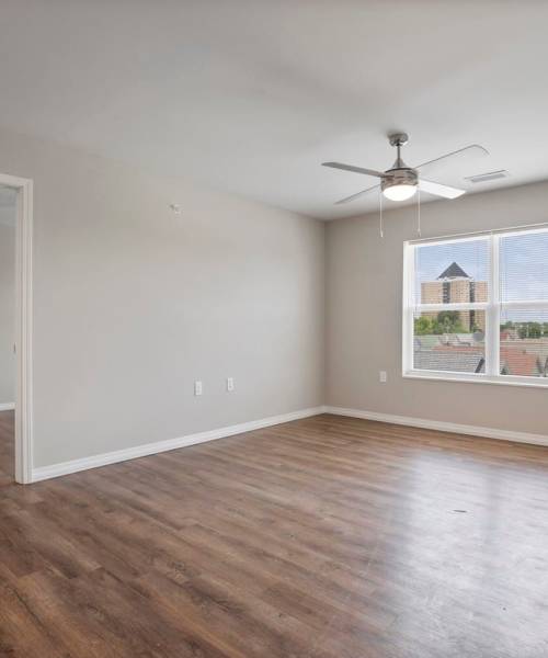 Wood-style flooring in bright bedroom at Atcheson Place Lofts in Columbus, Ohio