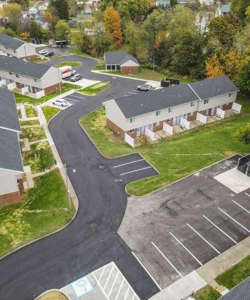 Paved parking area with townhomes at Plumly Townhomes in Barnesville, Ohio