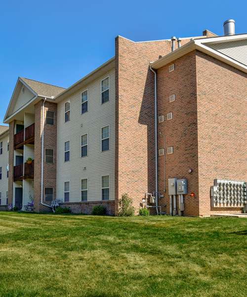 Brick exterior with green lawn at Tall Trees in Tiffin, Ohio