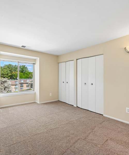Living room with a large window at Columbia Landing in Columbia, Maryland