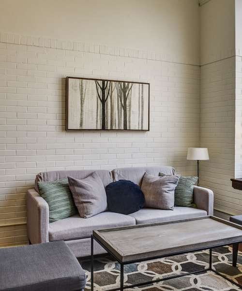 Cozy living room with textured wall at Everts Hill Senior Living Apartments in Circleville, Ohio