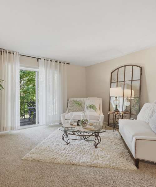 Living room with carpet flooring at Beau Jardin Apartments in St. Louis, Missouri