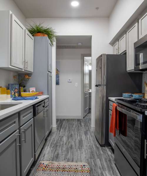 Narrow kitchen with stainless steel appliances at Brixton in Round Rock, Texas
