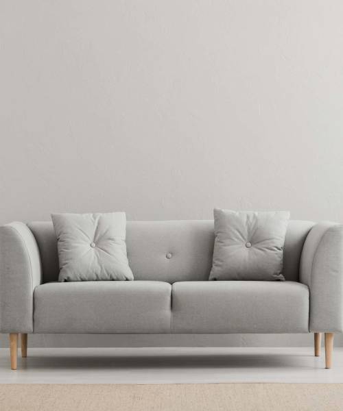 Gray sofa with two cushions at Prince Frederick Villas in Prince Frederick, Maryland
