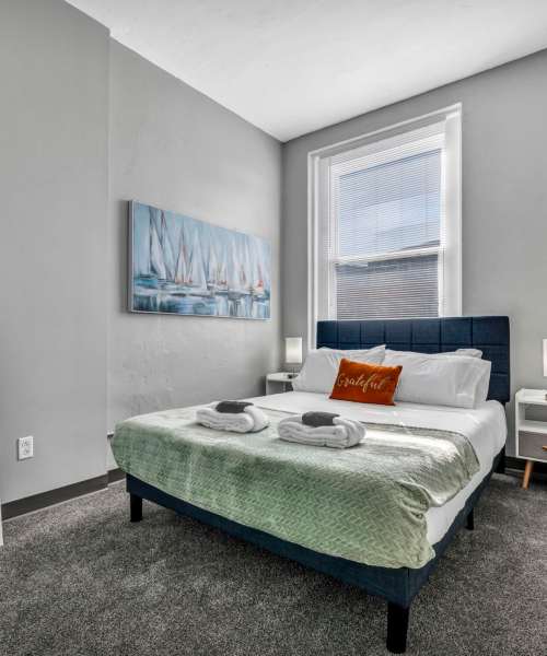 Cozy bedroom with plush carpeting at Huron Square and The Osborn in Cleveland, Ohio