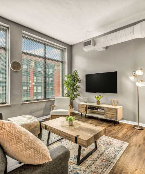 Bright living room with wood-style flooring at Huron Square and The Osborn in Cleveland, Ohio