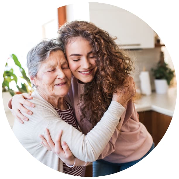 Resident and a younger family member hugging at a Ebenezer Senior Living community