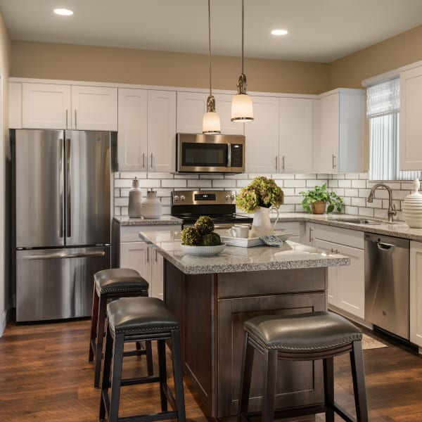 Modern kitchen with stainless-steel appliances in model home at San Piedra in Mesa, Arizona