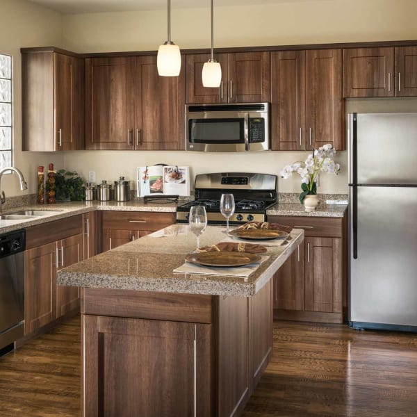 Contemporary kitchen with island with beautiful hardwood flooring at San Hacienda in Chandler, Arizona