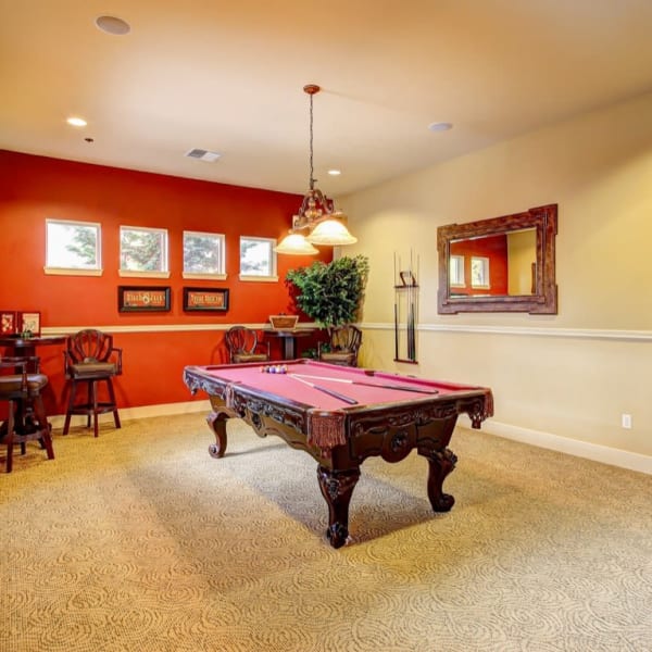 Billiards room with windows and seats at The Dakota Apartments in Lacey, Washington