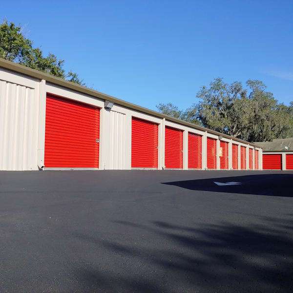 Outdoor storage units with bright doors at StorQuest Self Storage in Clearwater, Florida
