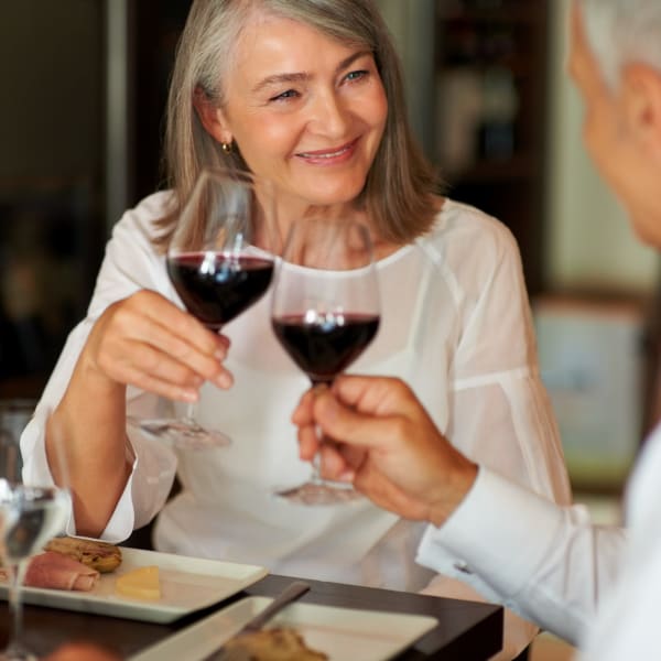 Resident couple toasting over wine at Quail Park at Morrison Ranch in Gilbert, Arizona