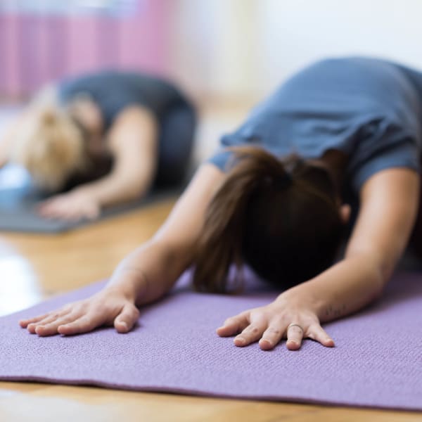 Residents doing some yoga in the fitness center at Wimberly at Deerwood in Jacksonville, Florida