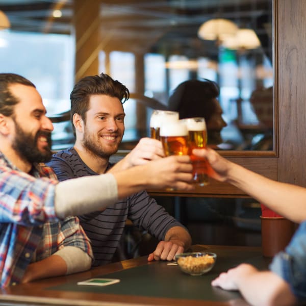 Resident friends raising their glasses to the good life at Olympus Court Apartments in Bakersfield, California