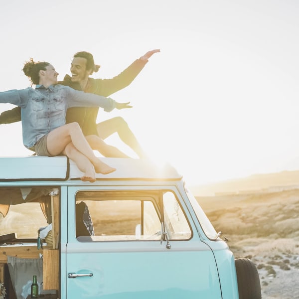 Resident couple pretending to surf on top of their van near Olympus Court Apartments in Bakersfield, California