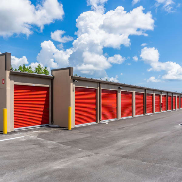 Exterior units with bright red doors at StorQuest Self Storage in Tarpon Springs, Florida