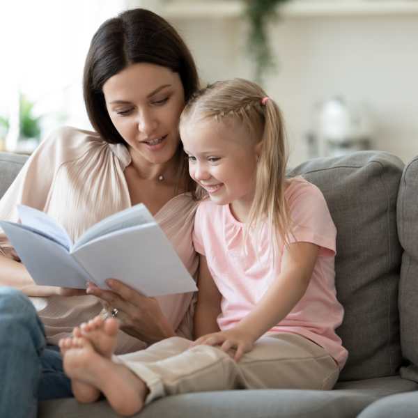 Residents reading book in their living room at The Lock at Flatirons in Broomfield, Colorado
