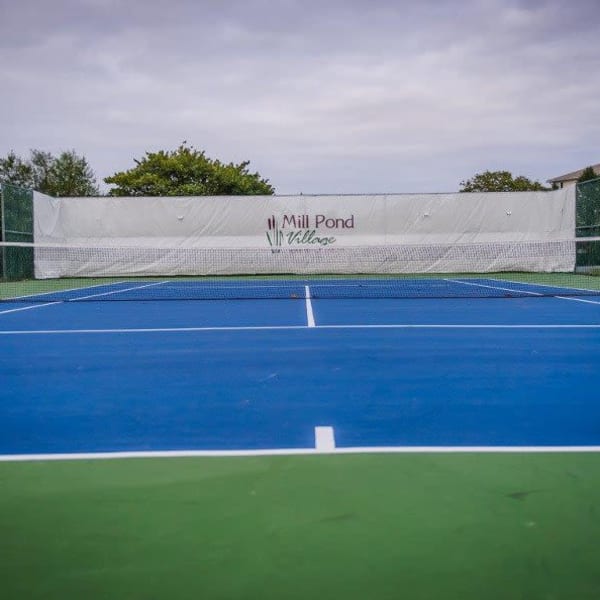 Full sized tennis court onsite for residents to use at Mill Pond Village Apartments in Salisbury, Maryland