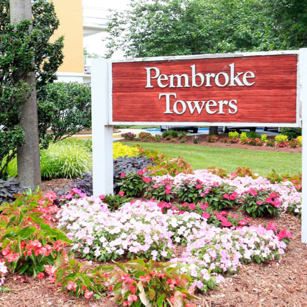 Exterior welcoming sign in front of the building at Pembroke Towers in Norfolk, Virginia