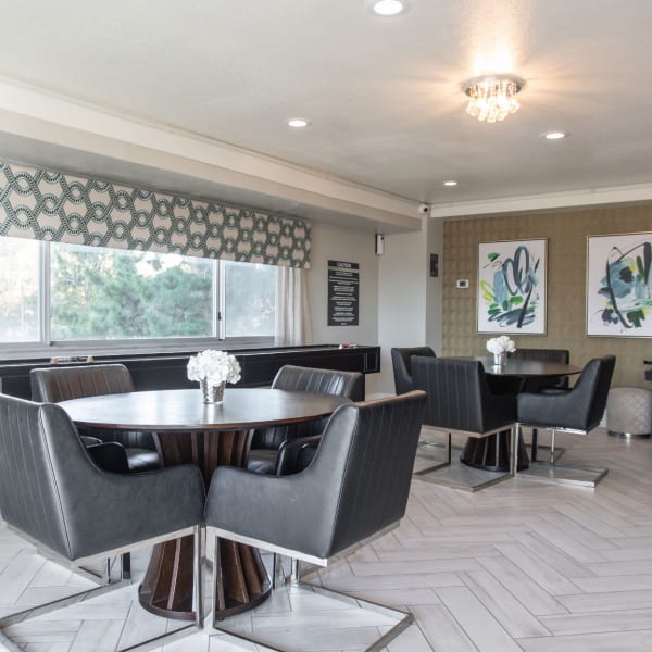 Resident lounge area with tables and chairs to eat and hang out in at Pembroke Towers in Norfolk, Virginia