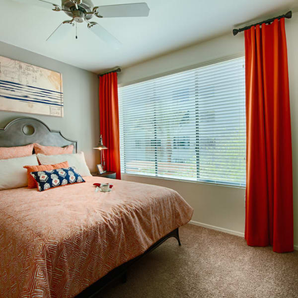 Well-decorated master bedroom with ceiling fan and bathroom at Cactus Forty-2 in Phoenix, Arizona