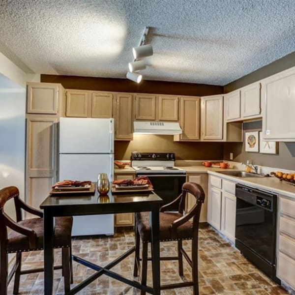 Gourmet kitchen with dining table at The Falls in Mission, Kansas